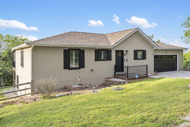 ranch-style house featuring roof with shingles, fence, a front yard, and a garage