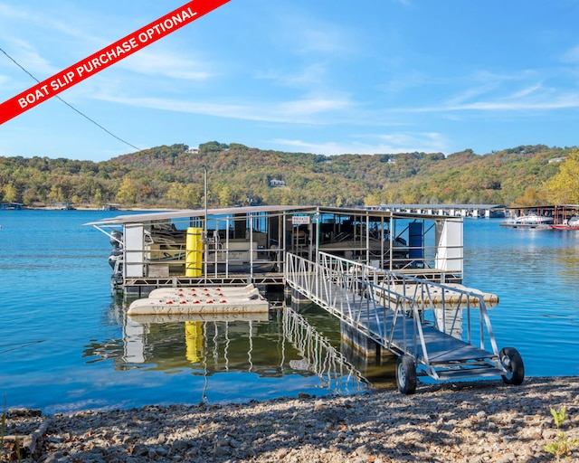 dock area featuring a view of trees and a water view
