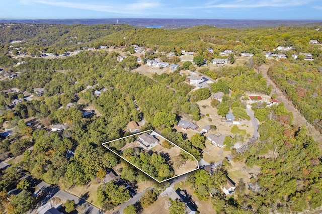 birds eye view of property featuring a wooded view