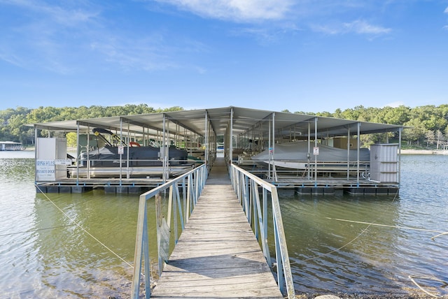 dock area with a water view and boat lift