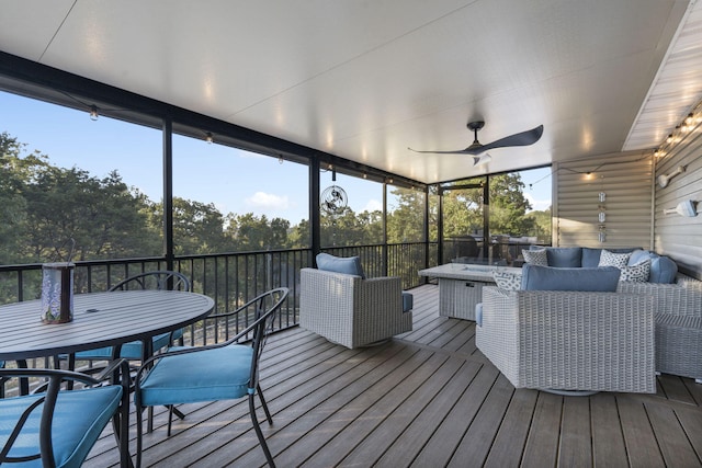 sunroom with an outdoor living space, a ceiling fan, and outdoor dining space