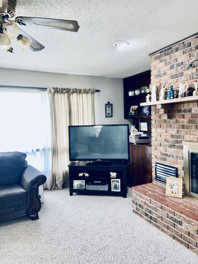 living area with a brick fireplace, a textured ceiling, ceiling fan, and carpet floors