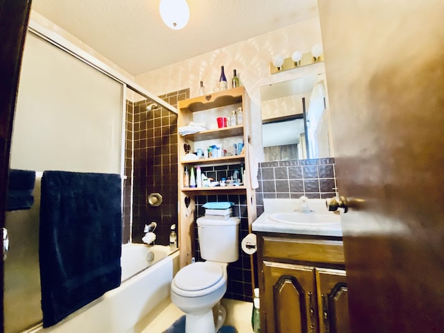 full bathroom with tile walls, vanity, decorative backsplash, bathing tub / shower combination, and toilet