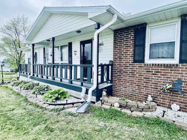 exterior space with covered porch and brick siding