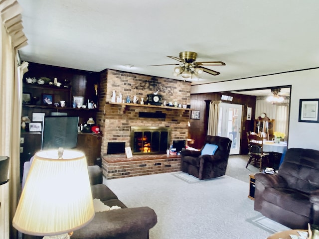 living room with a ceiling fan, carpet flooring, and a brick fireplace