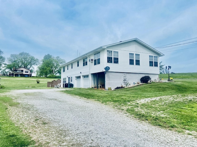view of home's exterior with driveway, a yard, and a garage