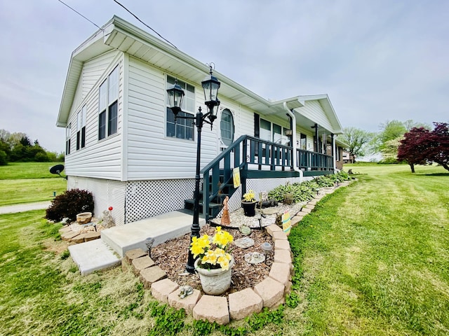 view of property exterior featuring a lawn and covered porch