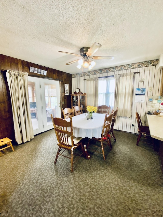 carpeted dining room featuring a textured ceiling, french doors, ceiling fan, and plenty of natural light