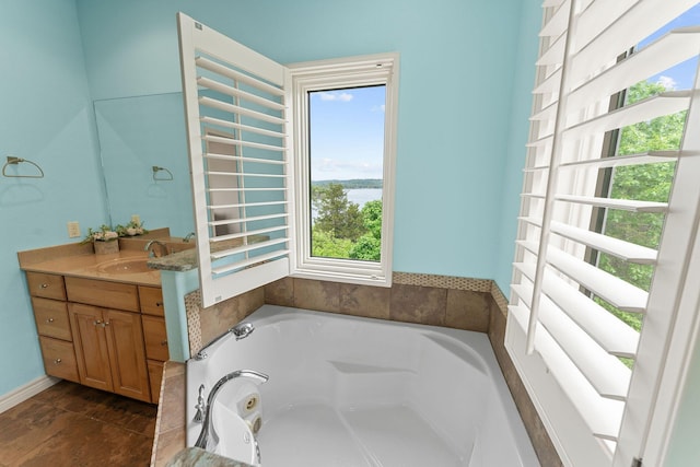46 Wild Rose Ln, Lampe, MO 65681 - bathroom featuring a tub with jets, vanity, and a water view