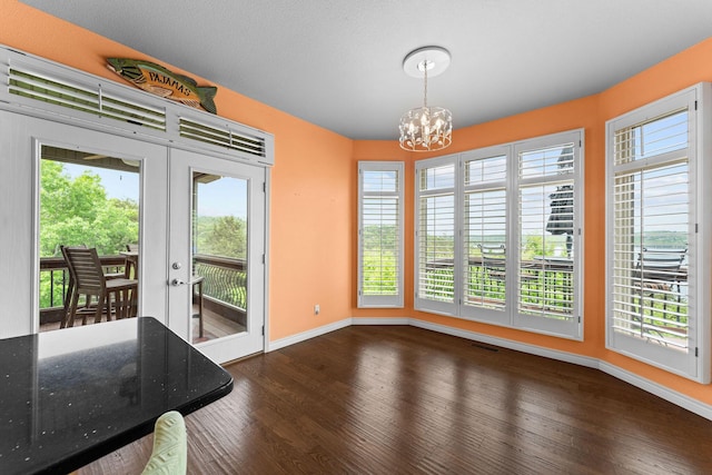 46 Wild Rose Ln, Lampe, MO 65681 - unfurnished dining area featuring an inviting chandelier, wood finished floors, and baseboards