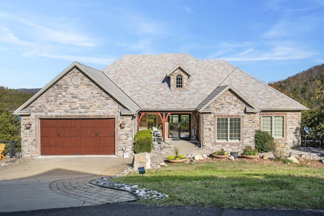 46 Wild Rose Ln, Lampe, MO 65681 - view of front of house featuring stone siding, concrete driveway, a front yard, and a garage