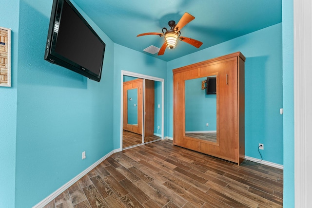 46 Wild Rose Ln, Lampe, MO 65681 - unfurnished bedroom with visible vents, dark wood-style flooring, a closet, and baseboards