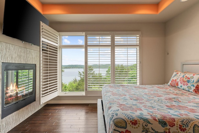 46 Wild Rose Ln, Lampe, MO 65681 - bedroom featuring a water view, multiple windows, and dark wood finished floors