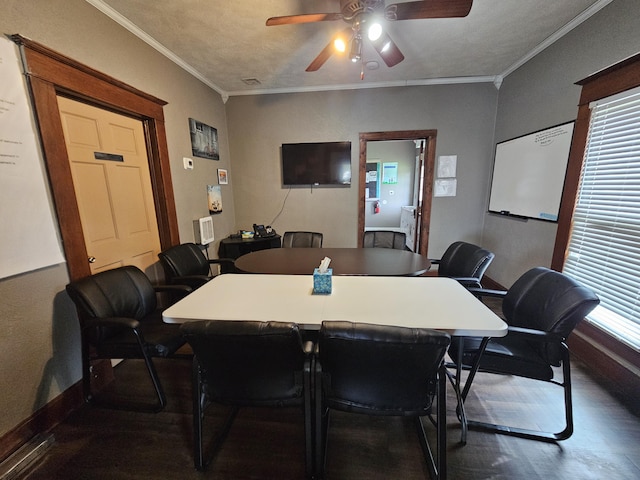 dining room featuring dark wood-style flooring, a ceiling fan, ornamental molding, and baseboards