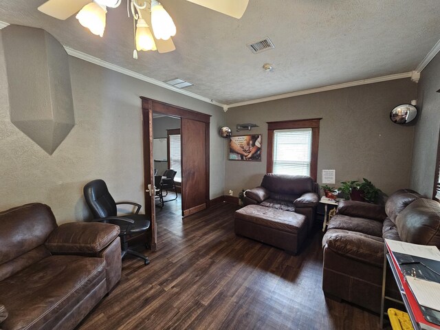 living room featuring visible vents, wood finished floors, a ceiling fan, and crown molding