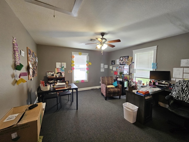 office with dark colored carpet, attic access, ceiling fan, baseboards, and visible vents