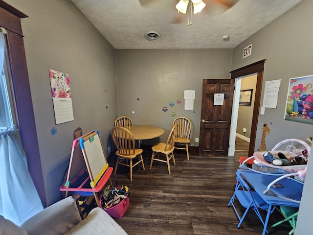 dining room with a ceiling fan, visible vents, wood finished floors, and baseboards