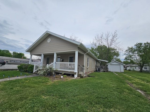 view of front of home with a garage, a porch, an outbuilding, and a front yard