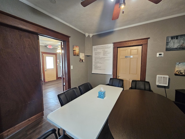 dining room featuring crown molding, ceiling fan, a textured wall, and wood finished floors
