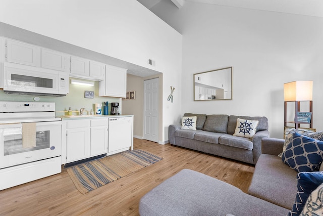 520 Abby Ln Unit 8, Branson, MO 65616 - living area with a high ceiling, light wood-style flooring, and baseboards