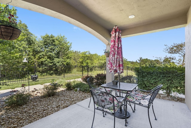 140 S Tuscany Dr Unit C, Hollister, MO 65672 - view of patio featuring fence and outdoor dining space