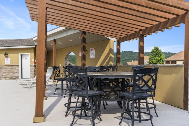 140 S Tuscany Dr Unit C, Hollister, MO 65672 - view of patio featuring a pergola and outdoor dining space