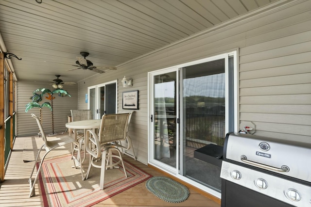 deck featuring a grill, ceiling fan, and outdoor dining area