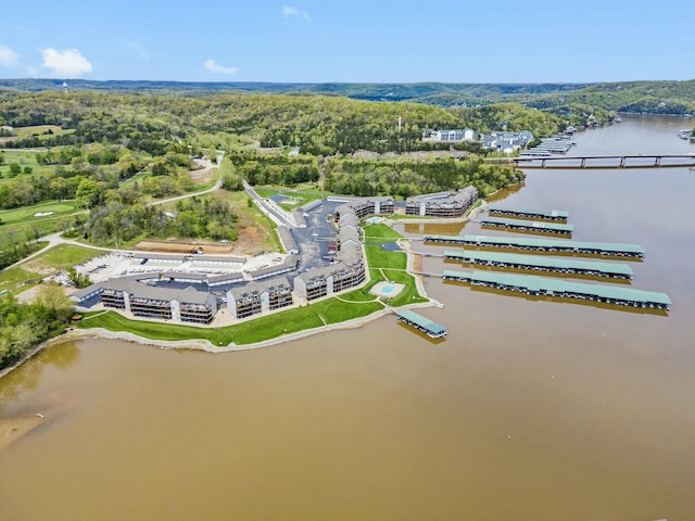 birds eye view of property featuring a water view and a view of trees