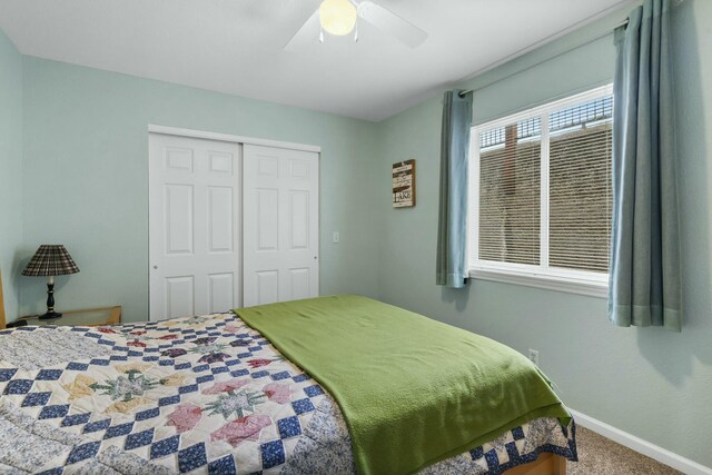 carpeted bedroom featuring a closet, a ceiling fan, and baseboards