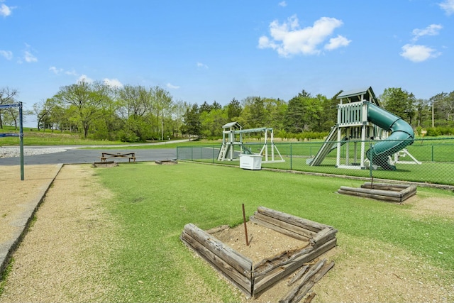 community jungle gym with a yard and fence