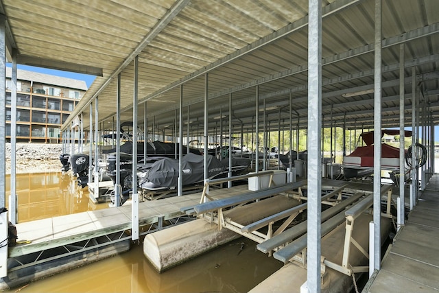 dock area with a water view and boat lift