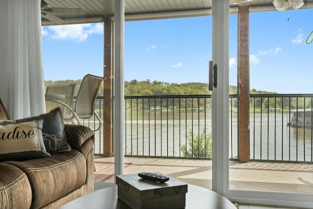 sunroom / solarium featuring a wealth of natural light and a water view