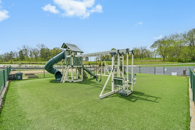 community playground featuring a lawn and fence