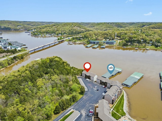 aerial view with a wooded view and a water view