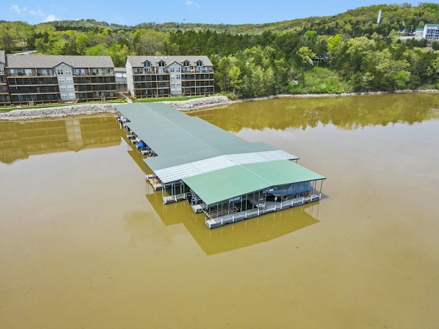 aerial view with a wooded view and a water view