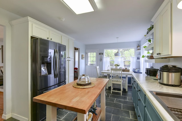 301 Oakview Dr, Ridgedale, MO 65739 - kitchen with stainless steel fridge, wood counters, open shelves, and white cabinetry