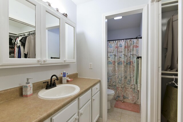 301 Oakview Dr, Ridgedale, MO 65739 - bathroom with a shower with shower curtain, toilet, tile patterned floors, vanity, and a walk in closet