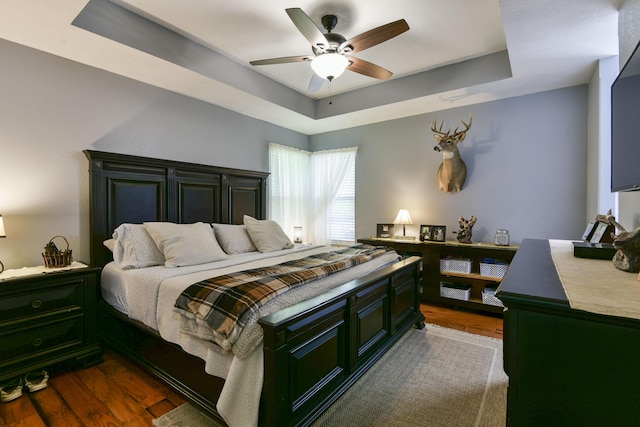 301 Oakview Dr, Ridgedale, MO 65739 - bedroom featuring dark wood-style floors, a ceiling fan, and a tray ceiling