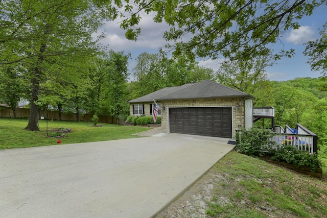301 Oakview Dr, Ridgedale, MO 65739 - view of front of home with a front yard, stone siding, concrete driveway, an attached garage, and fence
