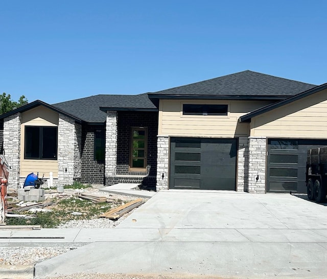 5958 S Clay Ave, Springfield, MO 65810 - view of front facade featuring stone siding, a garage, concrete driveway, and a shingled roof