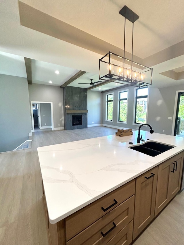 5958 S Clay Ave, Springfield, MO 65810 - kitchen featuring a sink, light wood-type flooring, open floor plan, light stone countertops, and recessed lighting