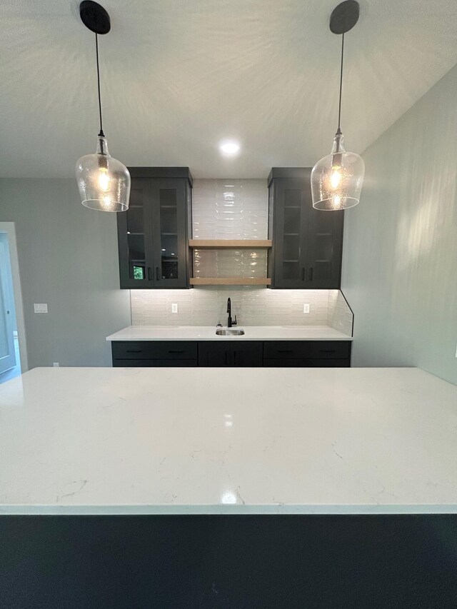 5958 S Clay Ave, Springfield, MO 65810 - kitchen with backsplash, a sink, glass insert cabinets, open shelves, and dark cabinets