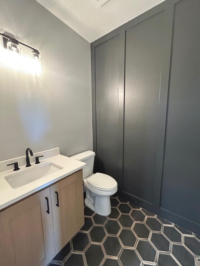 5958 S Clay Ave, Springfield, MO 65810 - half bathroom featuring toilet, vanity, and tile patterned flooring