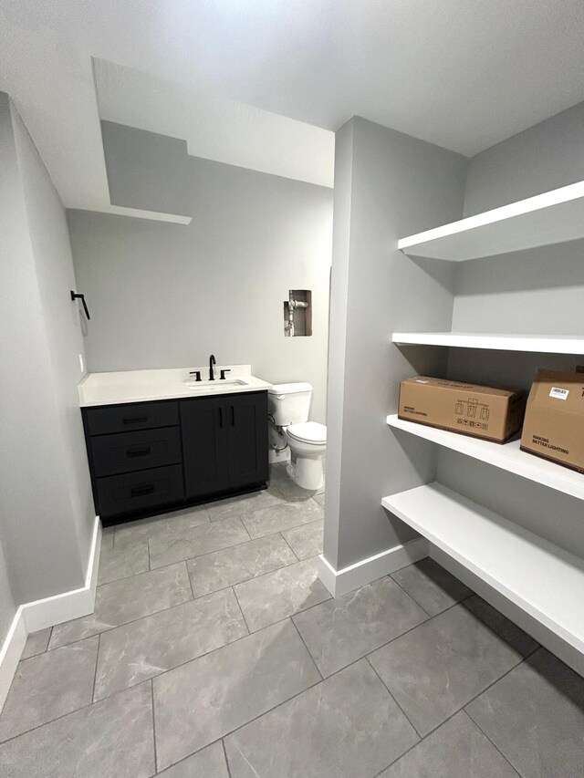 5958 S Clay Ave, Springfield, MO 65810 - bathroom with baseboards, toilet, and vanity