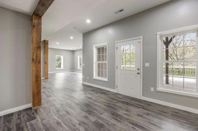 entrance foyer featuring visible vents, baseboards, and dark wood finished floors