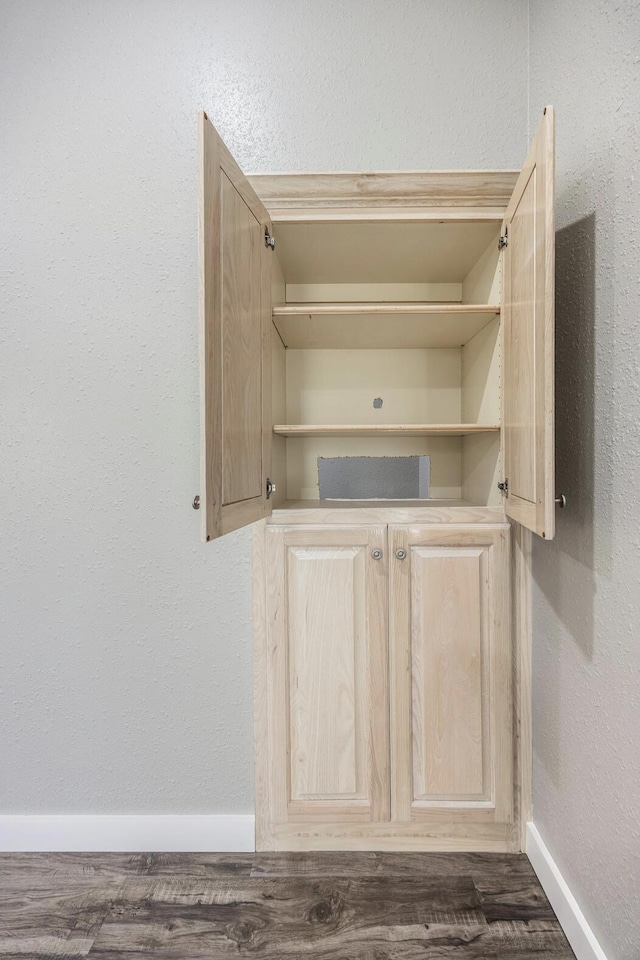 interior details featuring wood finished floors and baseboards