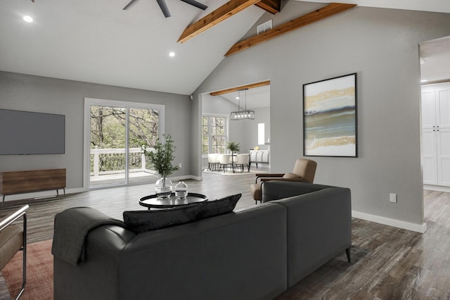 living room featuring visible vents, wood finished floors, a ceiling fan, and beamed ceiling