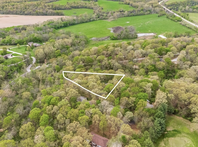 aerial view featuring a rural view and a view of trees
