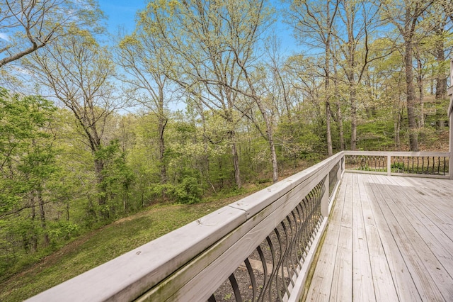 wooden terrace featuring a view of trees