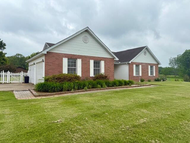 311 Cantrell, Mountain View, MO 65548 - view of side of property featuring brick siding and an attached garage
